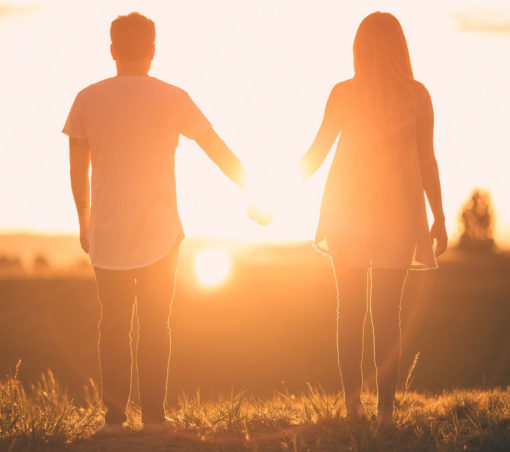 Couples session standing in sunset